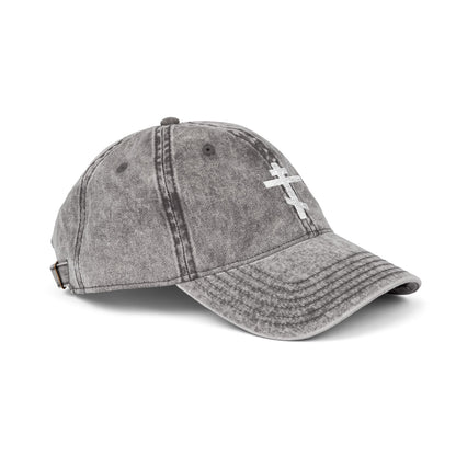 The Simple White Orthodox TriBar Cross cap features a minimalist embroidered cross symbolizing Christ’s sacrifice, a distressed gray finish, and an adjustable strap—perfect for expressing faith with style.