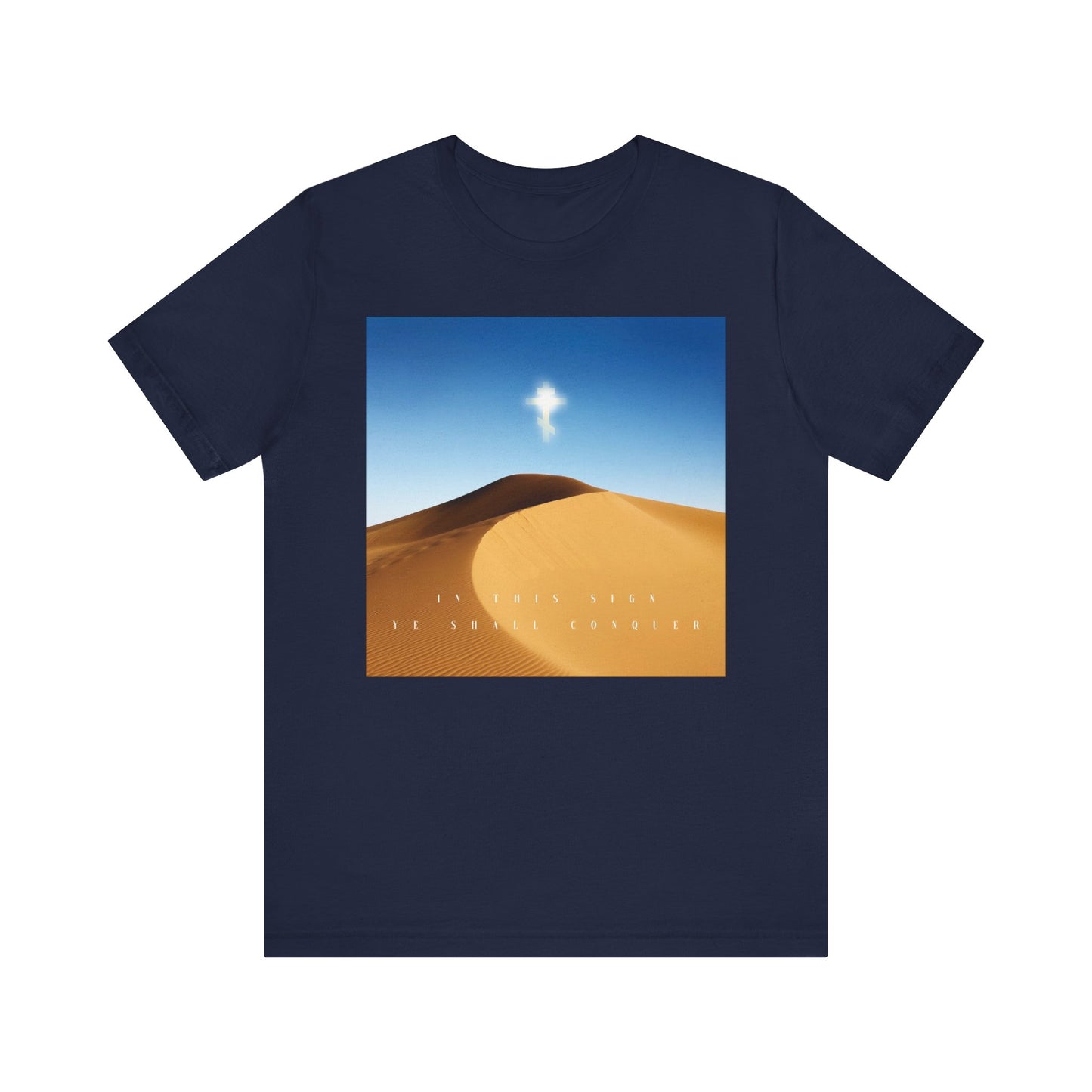 Navy unisex tee with a desert sun scene, blue sky, clouds, and the Cross. Text: "In This Sign Ye Shall Conquer." Lightweight Orthodox Christian cotton shirt—The Cross is the Might of Kings.