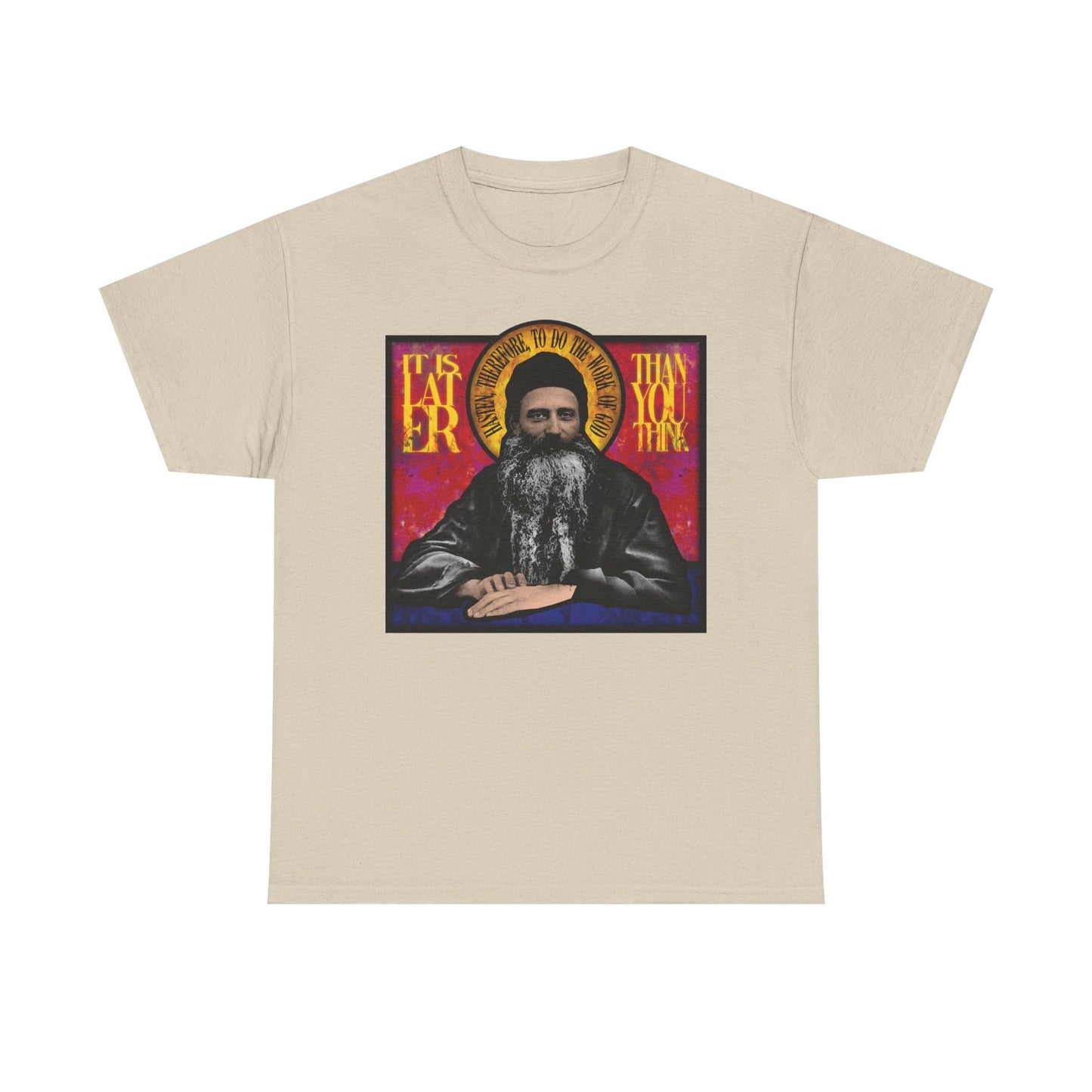 Sand-colored "It Is Later Than You Think" unisex t-shirt, featuring a stained glass illustration of Fr. Seraphim Rose—an American Orthodox monastic saint—and bold lettering that reflects on themes of salvation and the Kingdom of Heaven. Made from midweight cotton.