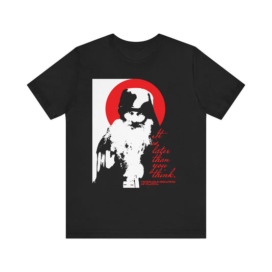 Black "It's Later Than You Think" unisex T-shirt featuring a high-contrast bearded figure, red sun, and thoughtful text inspired by Fr Seraphim Rose—a subtle memento mori echoing themes from Orthodox spiritual literature and the call to spiritual discipline. Made from lightweight cotton.