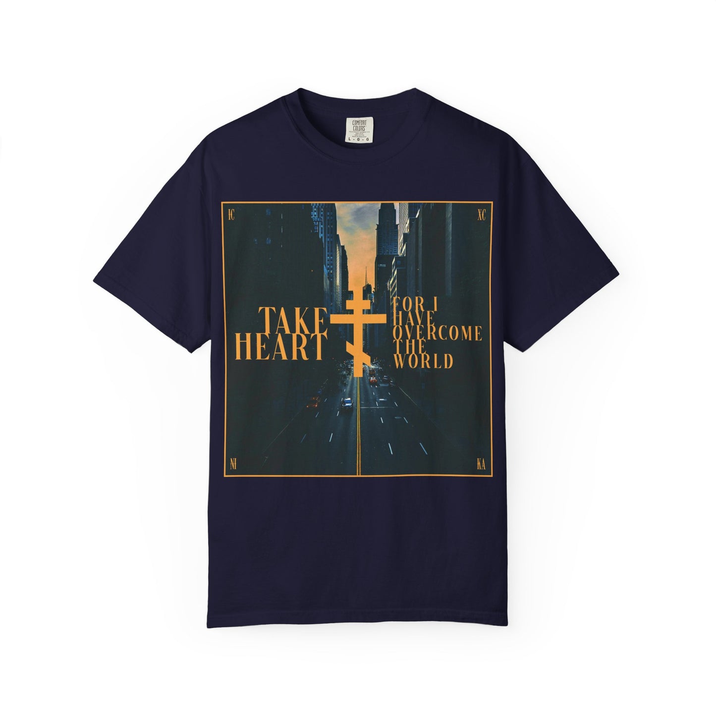 True Navy heavyweight cotton unisex tee featuring a modern city street scene design with a yellow double cross and the text "Take Heart, For I Have Overcome the World (John 16:33)," inspired by the promise that sorrow is turned into joy.