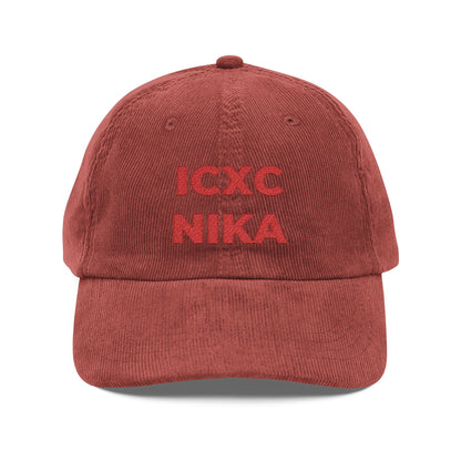 A burgundy cotton corduroy cap featuring the ICXC NIKA Christogram—Orthodox Christian symbol for "Jesus Christ Conquers"—embroidered on the front.