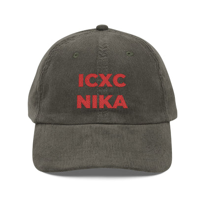 An olive cotton corduroy cap with red embroidered ICXC NIKA text—a classic Orthodox Christogram meaning "Jesus Christ Conquers"—on the front.