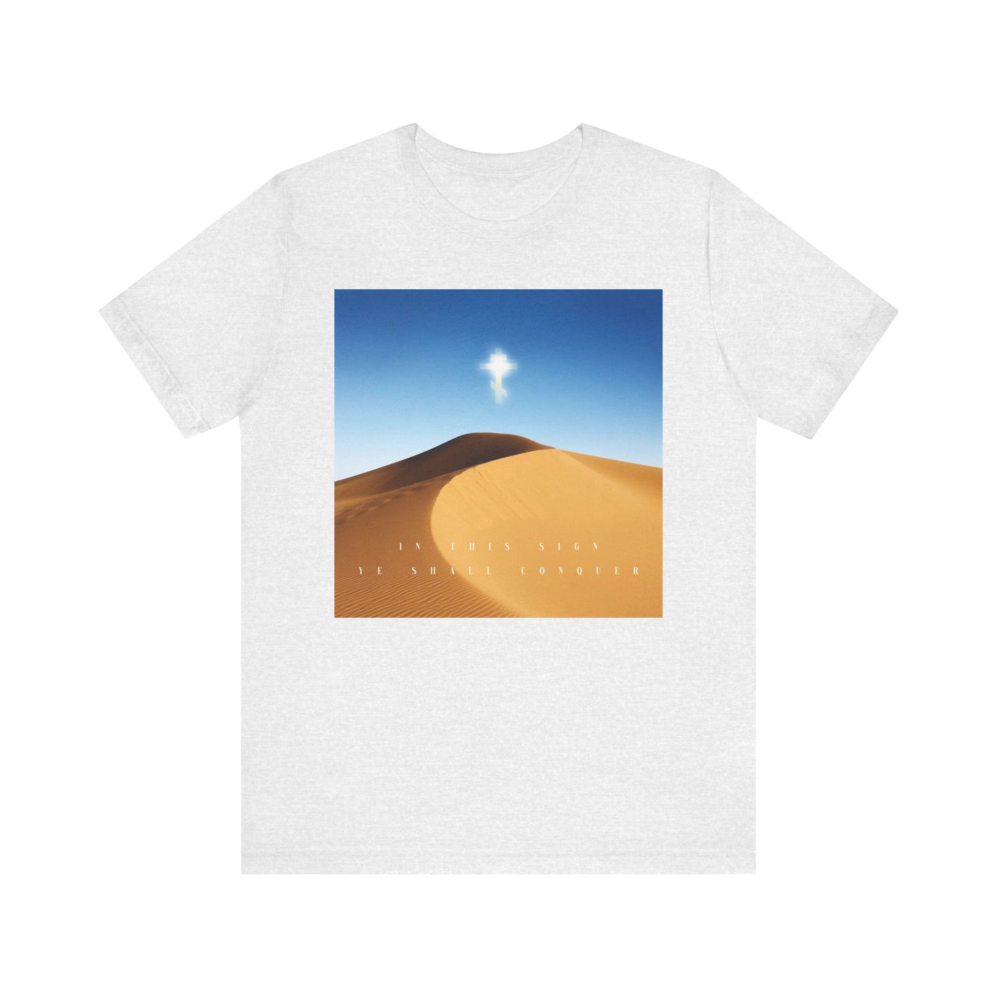 Ash-colored tee featuring a desert sun scene with blue sky, single cloud, and “By this sign ye shall conquer” text. Lightweight cotton unisex shirt celebrating Orthodox Christian faith and the power of the Cross.