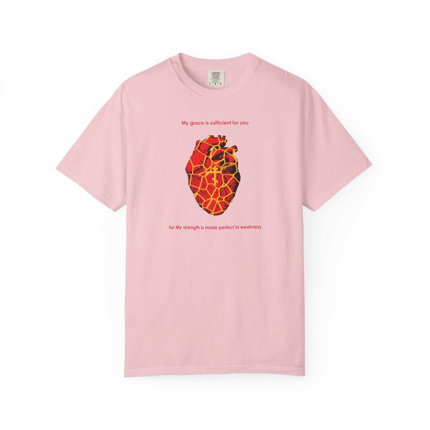 Blossom-colored heavyweight cotton unisex tee featuring a Kintsugi-style golden broken heart, an Orthodox Cross, and the text: "My Strength is Made Perfect in Weakness" (2 Cor 12:9)—a design inspired by the art of Kintsugi to show how even a broken spirit can be mended with grace.