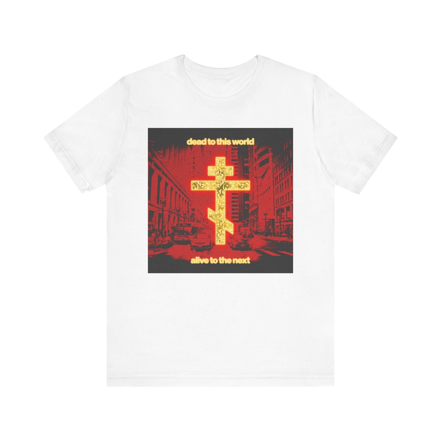White “Dead to This World Alive to the Next” Orthodox Christian tee features a glowing gold cross, red cityscape, and yellow text—echoing St. Ignatius Brianchaninov’s reflections on death and eternity. Lightweight cotton unisex shirt.