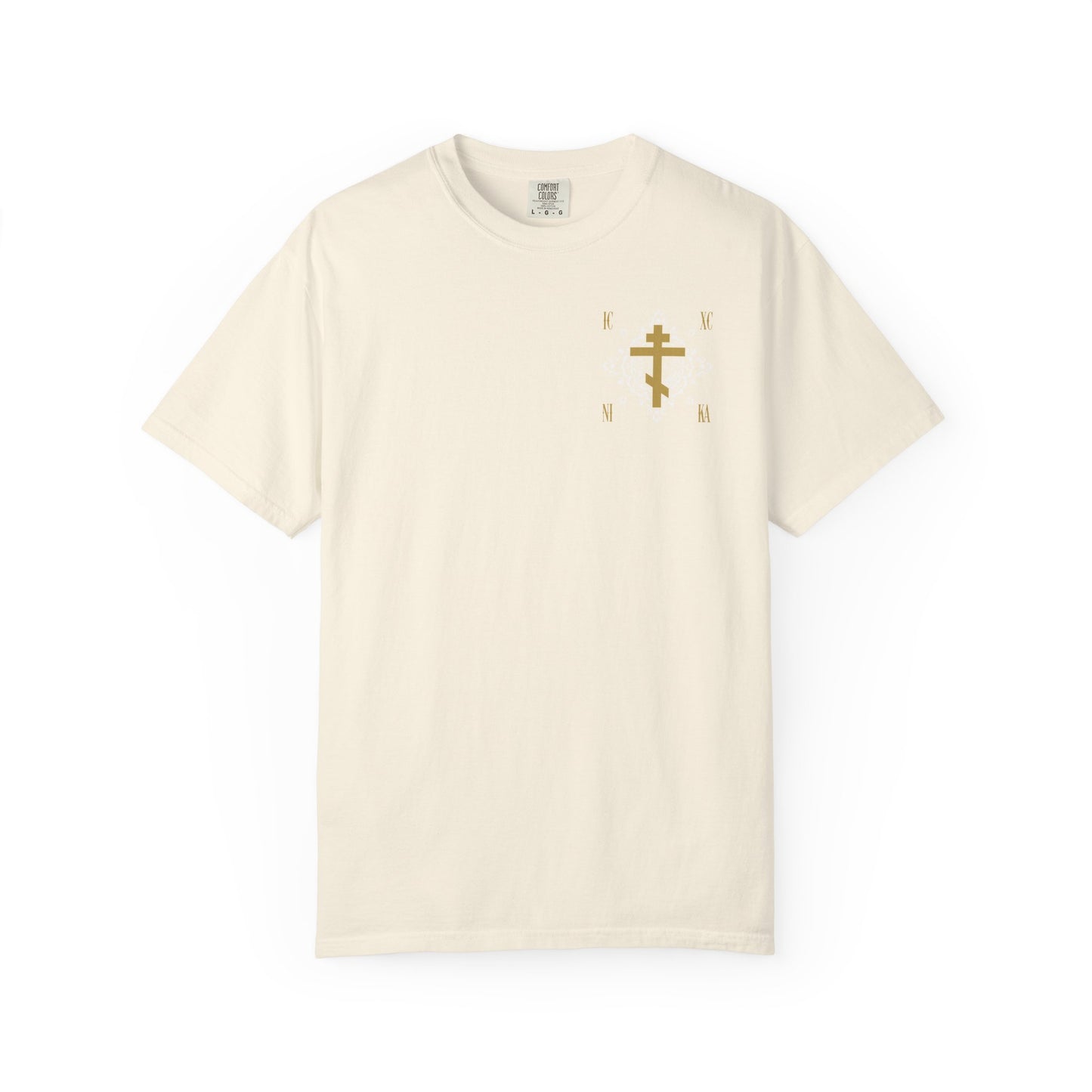 Ivory heavyweight cotton unisex T-shirt featuring a small gold Orthodox Cross ICXC NIKA with ornate floral pattern and "Jesus Christ Conquers" design on the upper left chest.